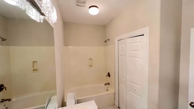 a bathroom with a bathtub and a shower