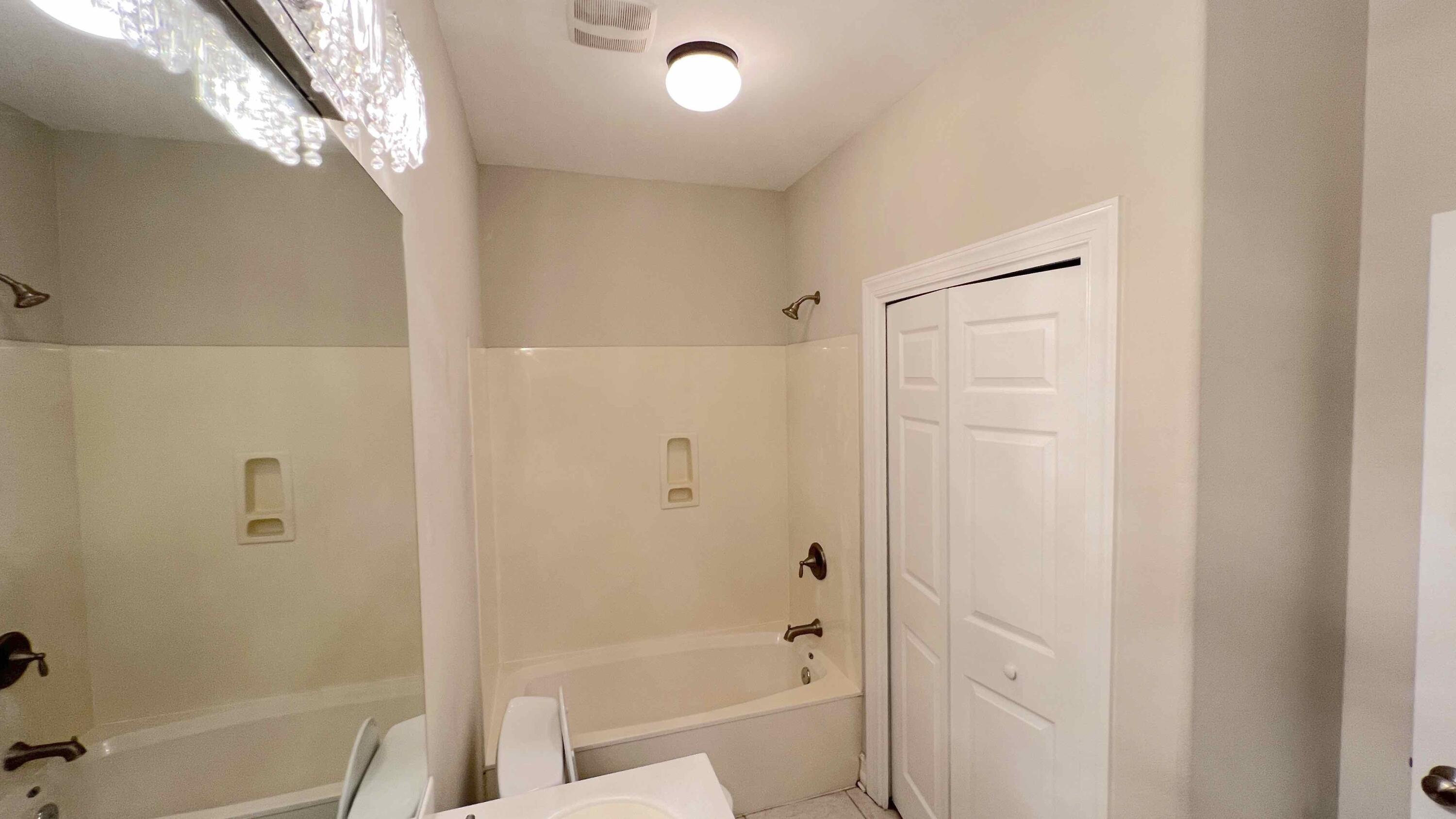 4230 Jade Loop Destin, FL 32541 - Photo 14 of 37 a bathroom with a bathtub and a shower
