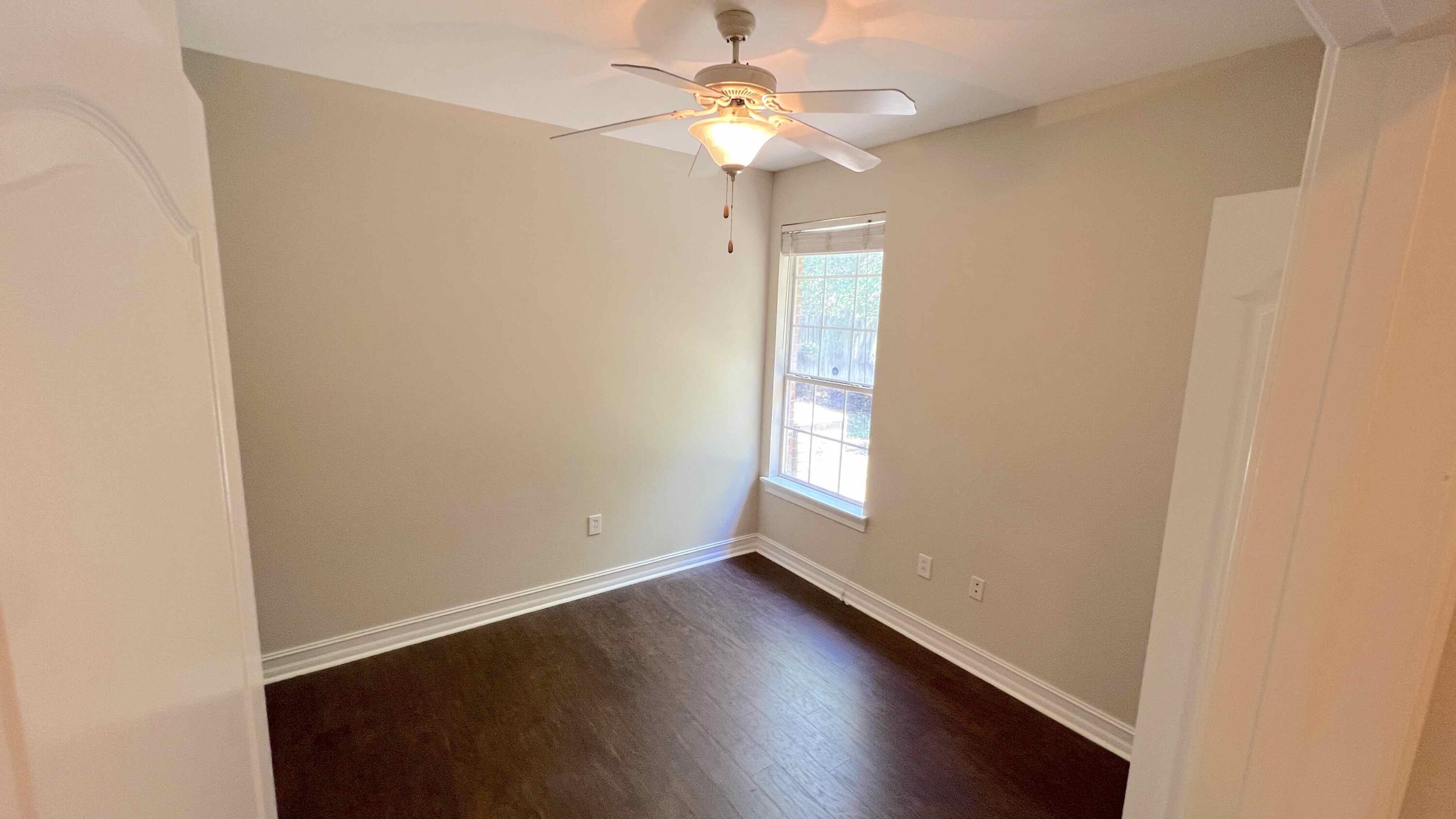 4230 Jade Loop Destin, FL 32541 - Photo 16 of 37 an empty room with a window and a chandelier fan