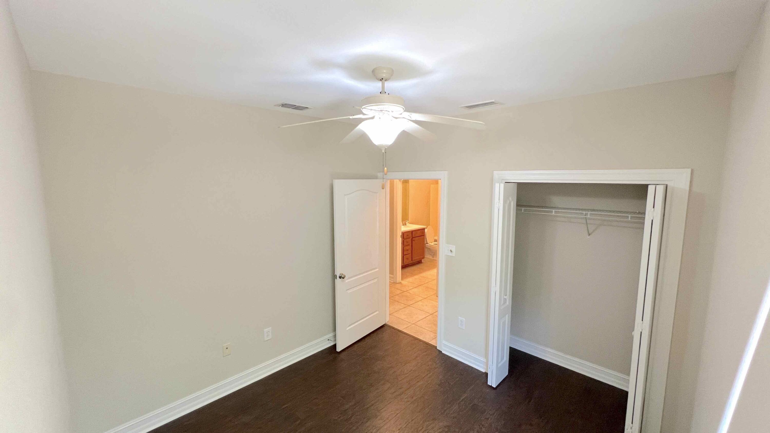 4230 Jade Loop Destin, FL 32541 - Photo 19 of 37 an empty room with a window and a ceiling fan