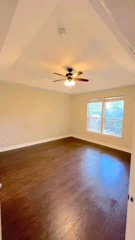 a view of a room with wooden floor and white walls
