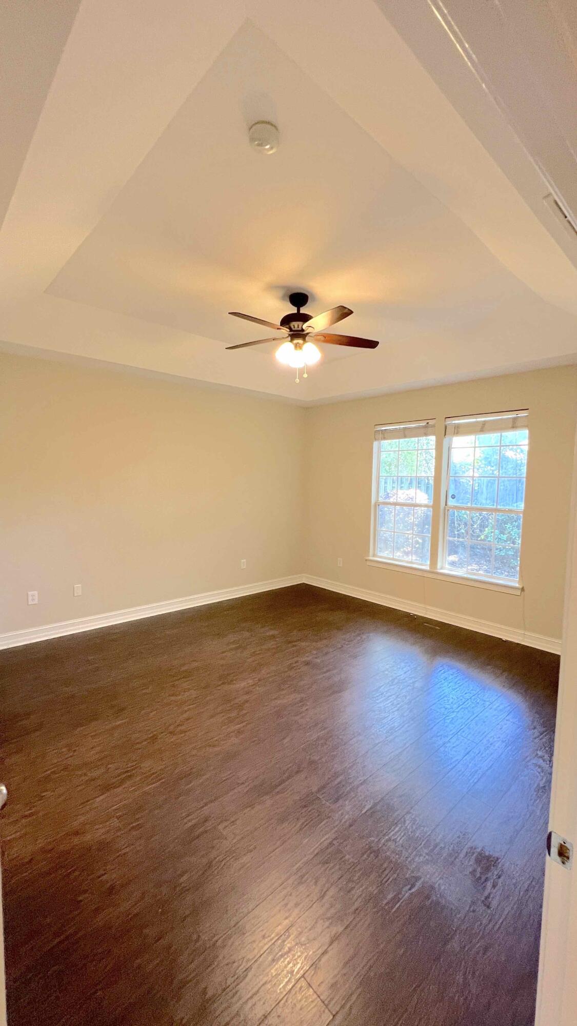 4230 Jade Loop Destin, FL 32541 - Photo 26 of 37 a view of a room with wooden floor and white walls