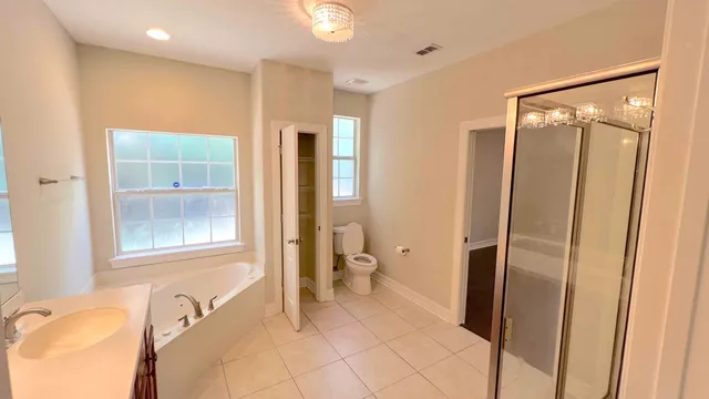 a spacious bathroom with a granite countertop sink and a mirror