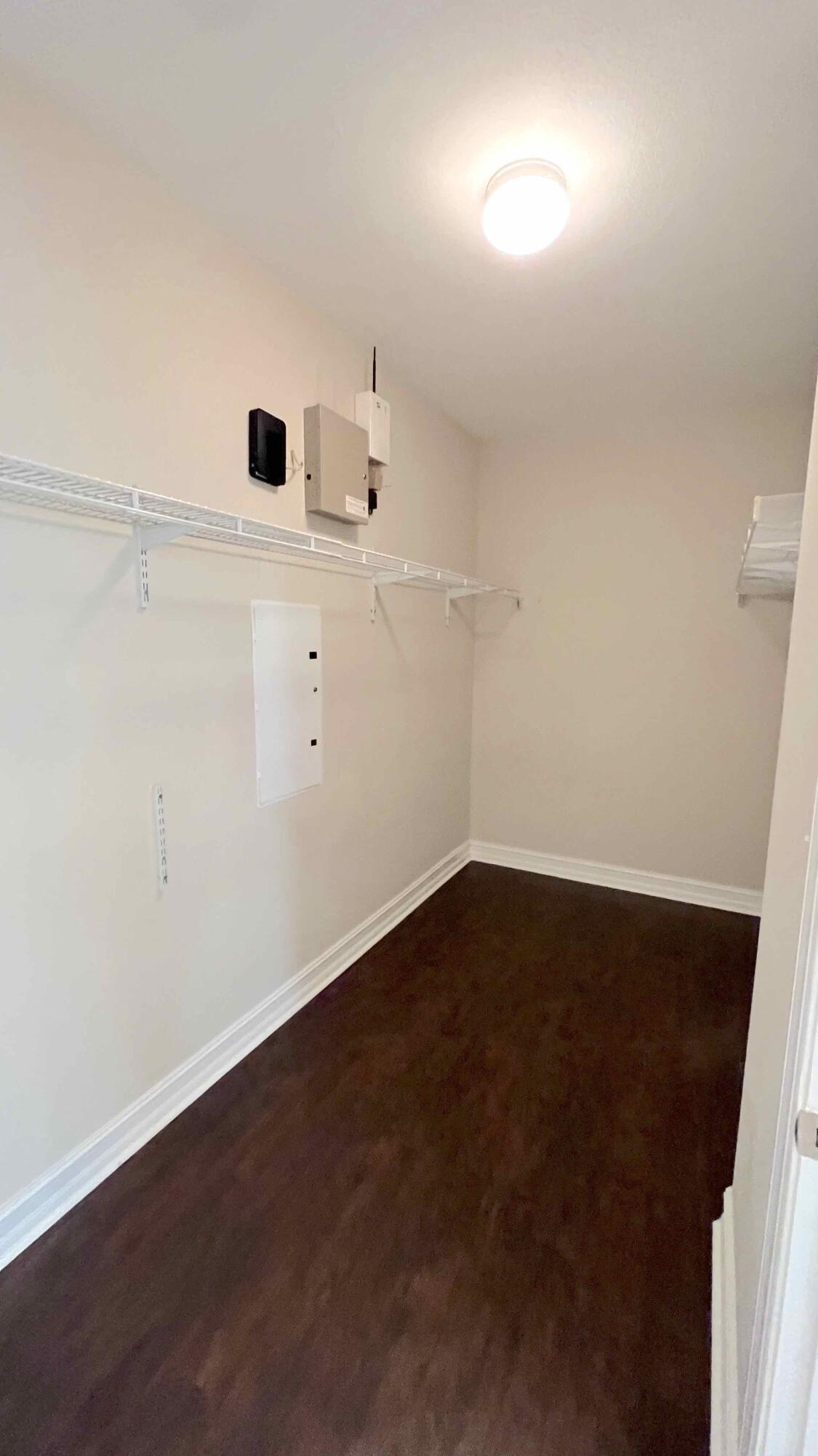 4230 Jade Loop Destin, FL 32541 - Photo 30 of 37 an empty room with wooden floor and windows