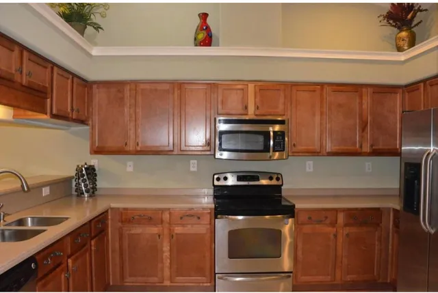 a kitchen with a sink a stove and cabinets
