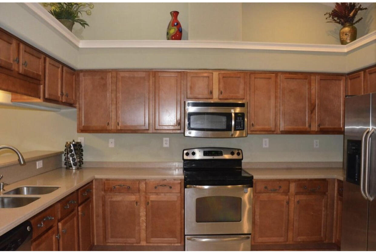 4230 Jade Loop Destin, FL 32541 - Photo 33 of 37 a kitchen with a sink a stove and cabinets