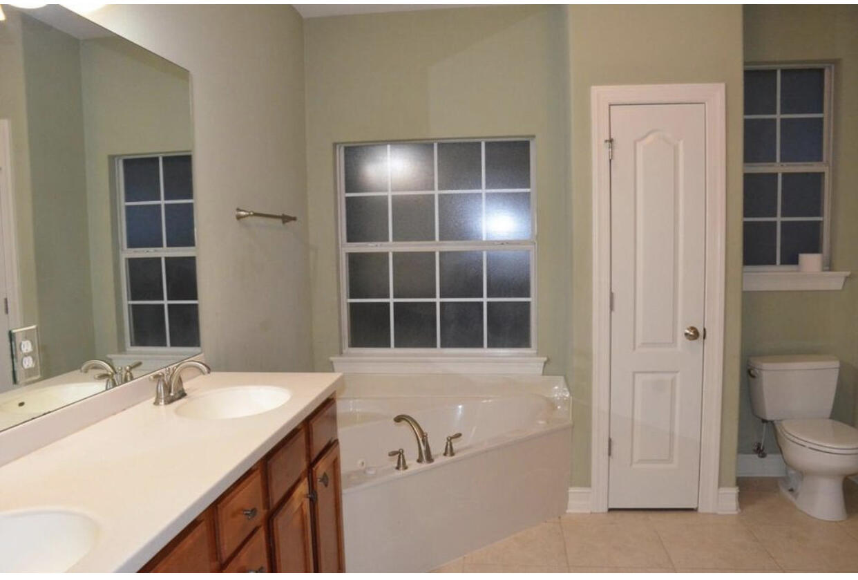4230 Jade Loop Destin, FL 32541 - Photo 35 of 37 a bathroom with a sink a toilet and shower