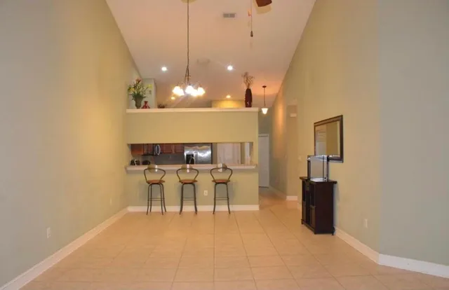 a view of a dining room with furniture and a chandelier