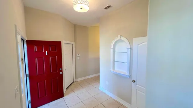 a view of a hallway to rooms