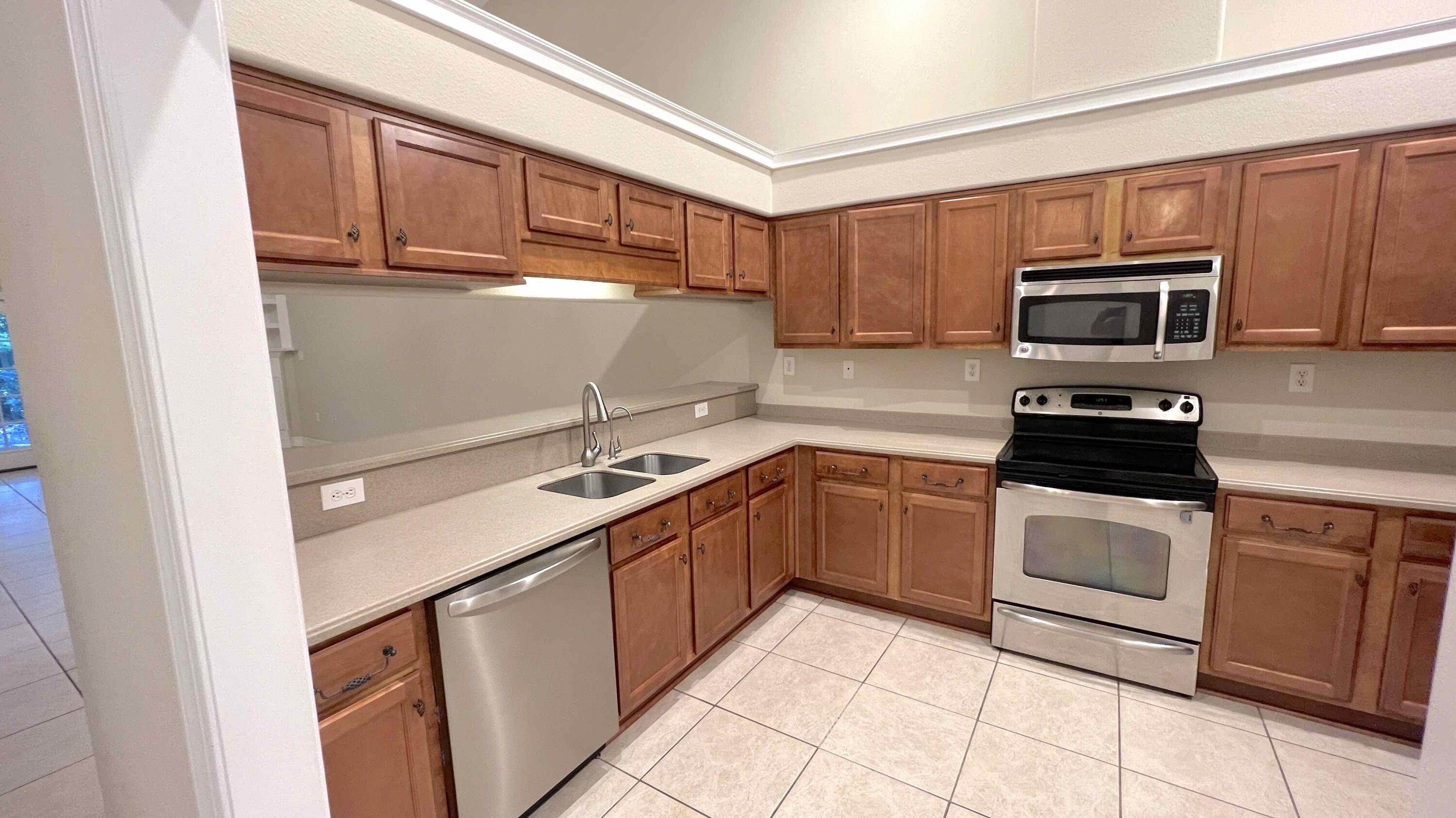4230 Jade Loop Destin, FL 32541 - Photo 8 of 37 a kitchen with a sink stove and microwave