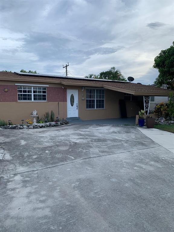 7450 Freedom Street Hollywood, FL 33024 - Photo 2 of 9 a front view of a house with a yard