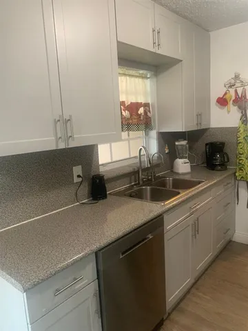 a kitchen with a sink and cabinets