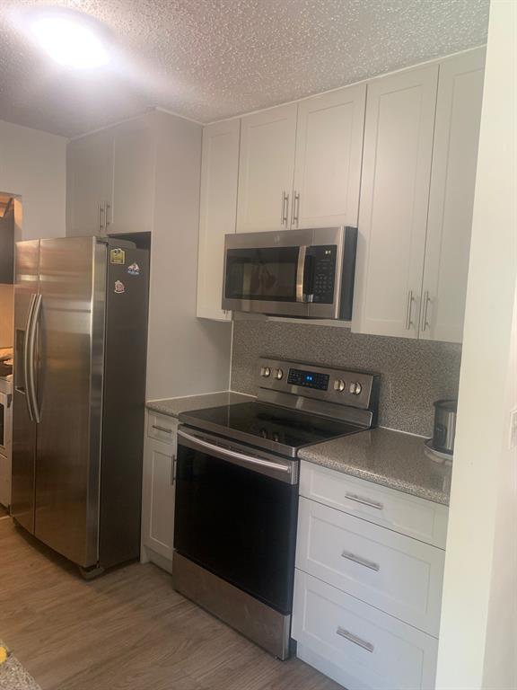 7450 Freedom Street Hollywood, FL 33024 - Photo 4 of 9 a kitchen with a refrigerator stove and microwave