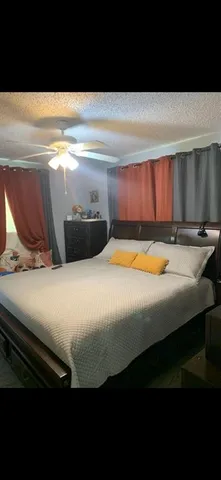 a bedroom with a bed and window