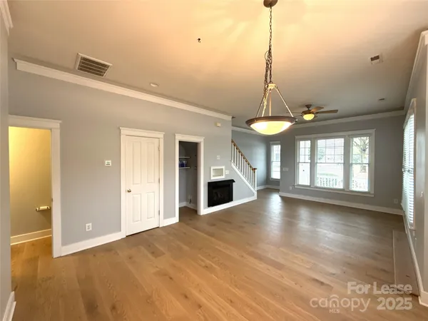 a view of a room with wooden floor