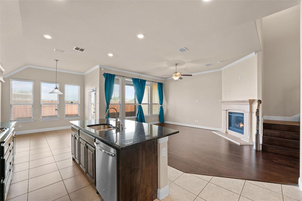 600 Fishback Circle Plano, TX 75074 - Photo 29 of 38 a kitchen with granite countertop a sink stove and cabinets