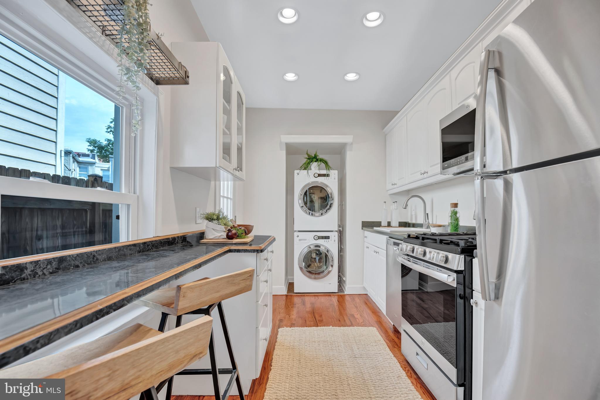 1437 Duke Street Alexandria, VA 22314 - Photo 12 of 45 a kitchen with stainless steel appliances a stove a sink and a microwave