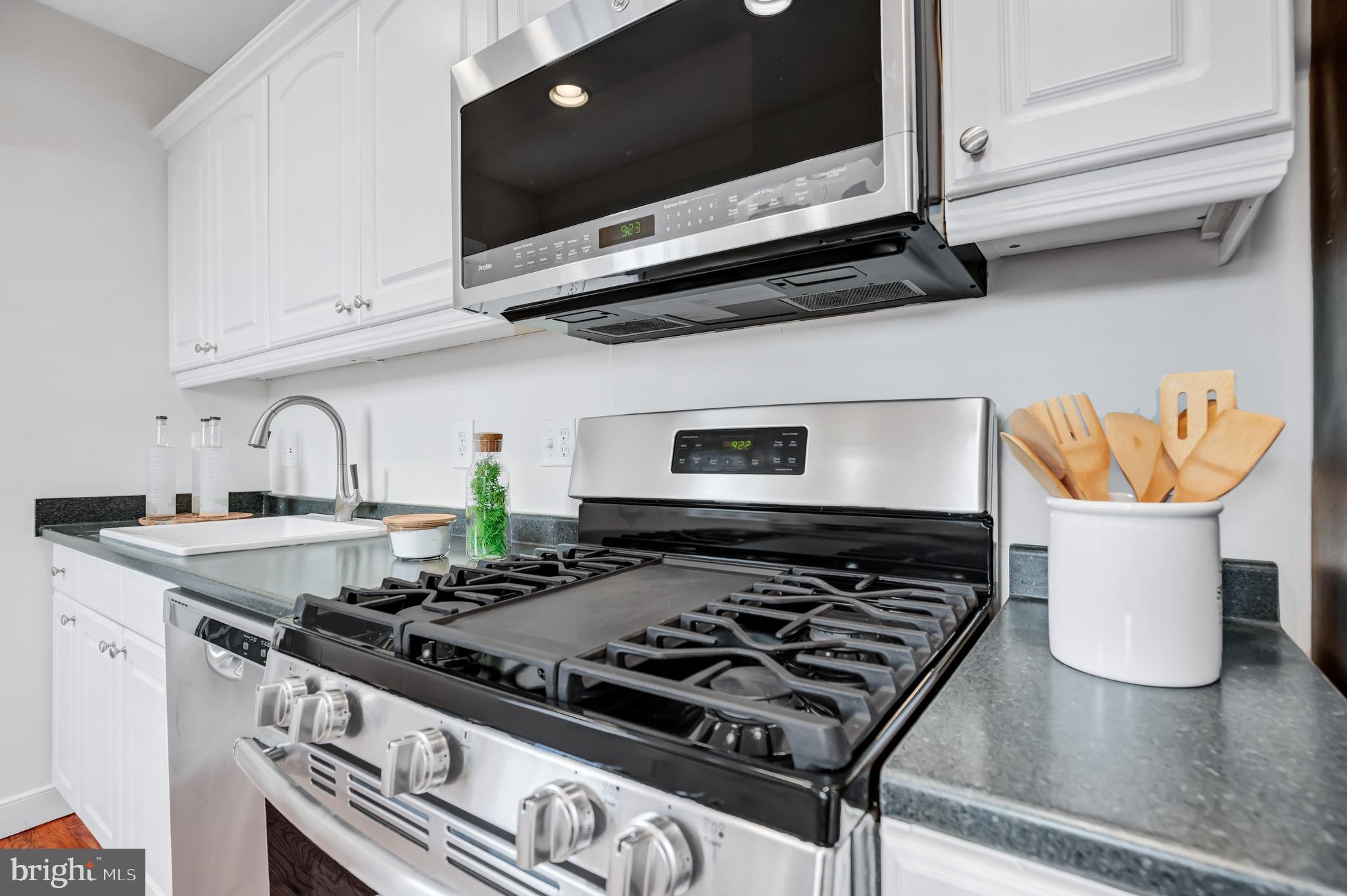 1437 Duke Street Alexandria, VA 22314 - Photo 13 of 45 a stove top oven sitting inside of a kitchen