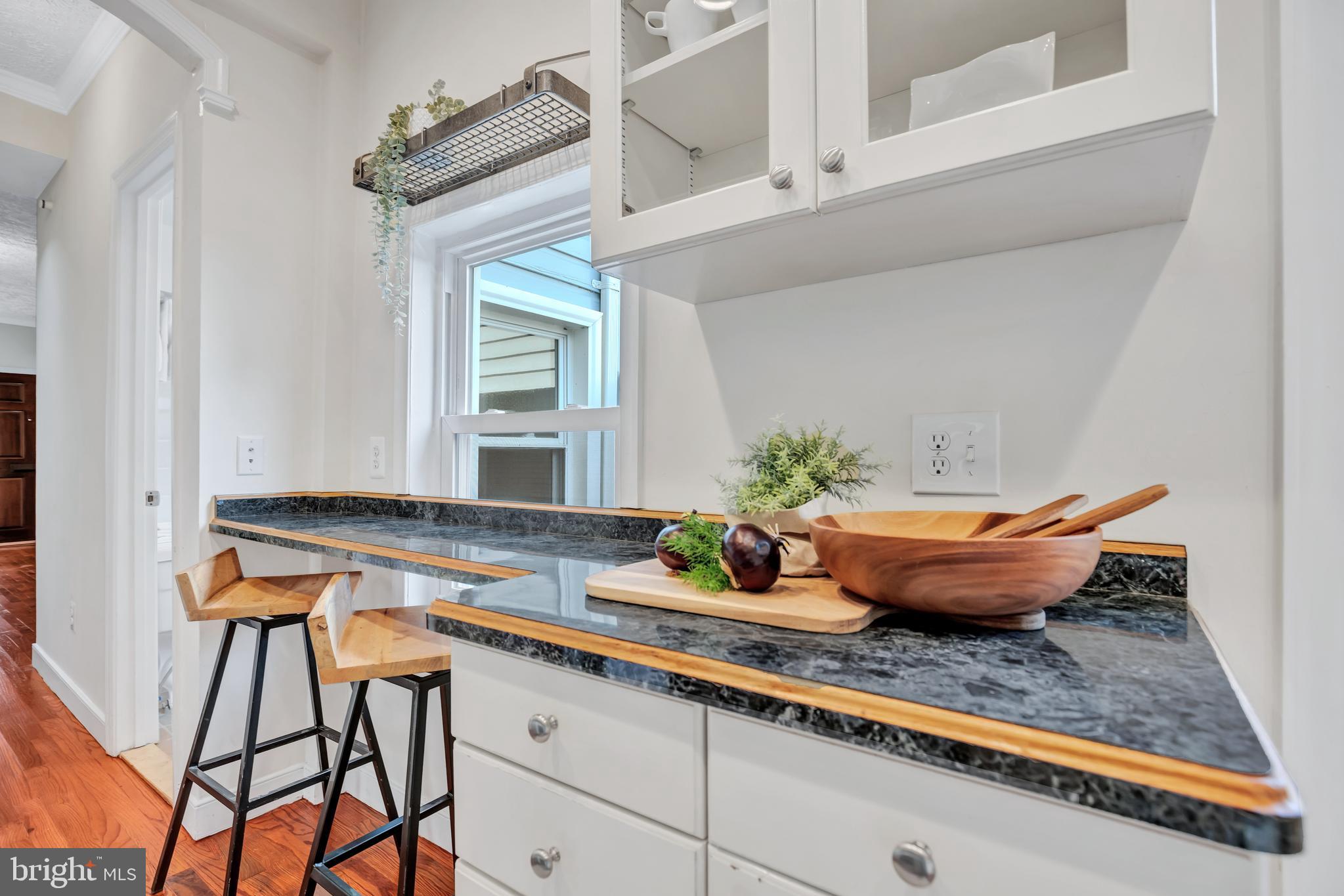 1437 Duke Street Alexandria, VA 22314 - Photo 17 of 45 a table chair sitting in a kitchen next to a window