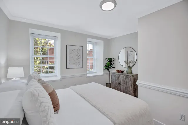 a bed room with a bed mirror and window