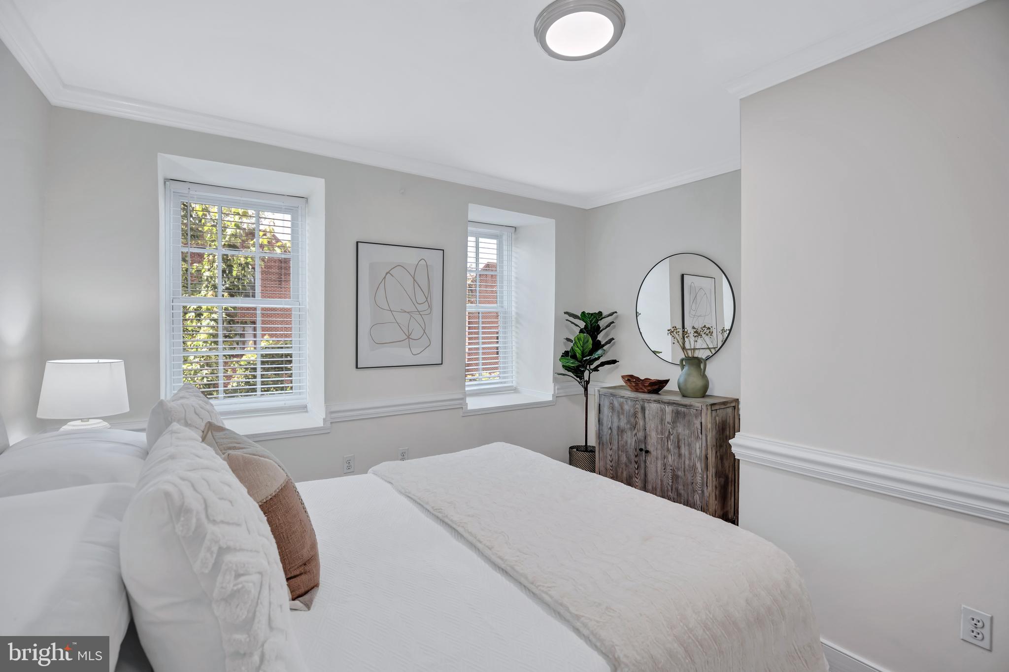 1437 Duke Street Alexandria, VA 22314 - Photo 21 of 45 a bed room with a bed mirror and window