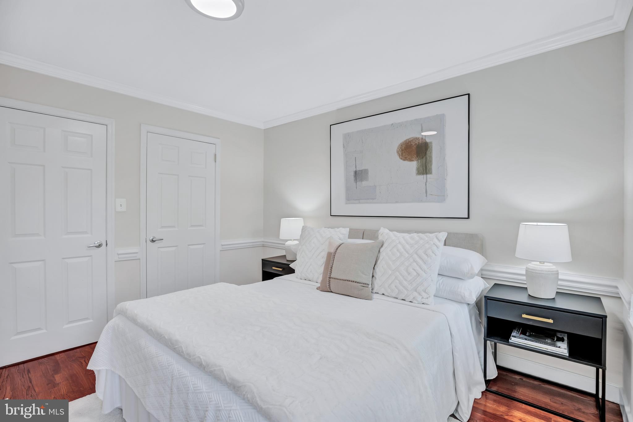 1437 Duke Street Alexandria, VA 22314 - Photo 22 of 45 a bedroom with a bed and a lamp on table
