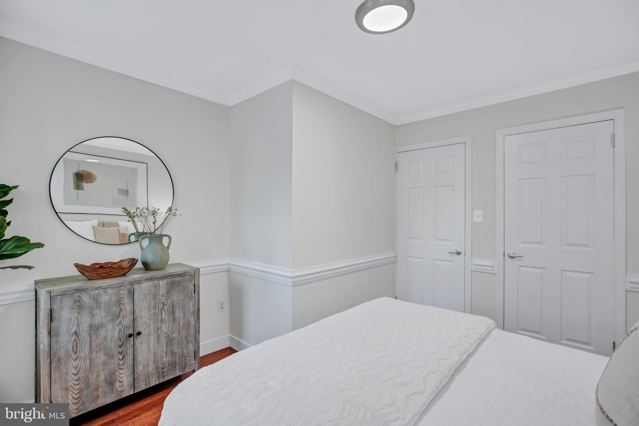 1437 Duke Street Alexandria, VA 22314 - Photo 23 of 45 a bedroom with a bed a mirror with outer view