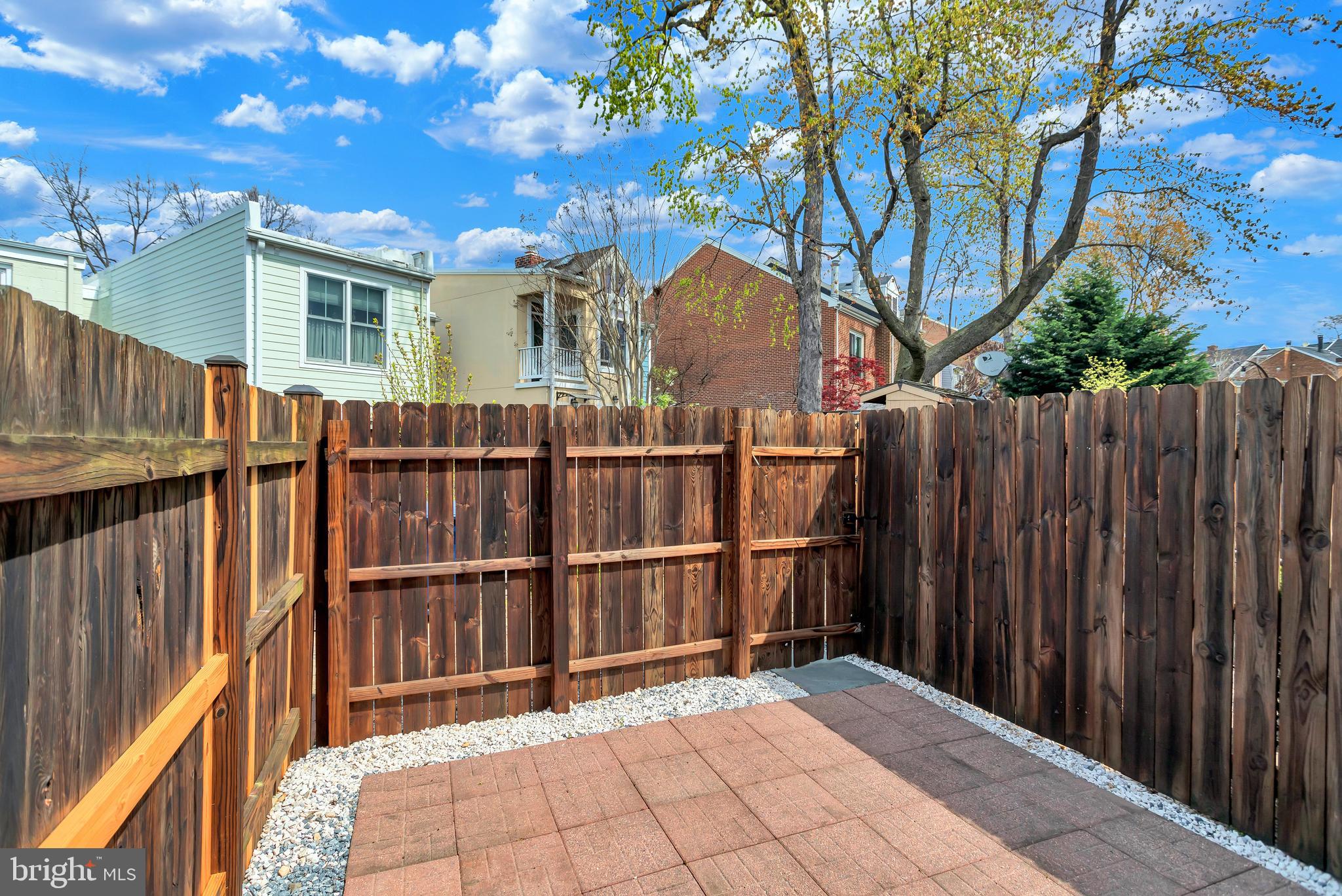 1437 Duke Street Alexandria, VA 22314 - Photo 28 of 45 a view of backyard with wooden fence and trees