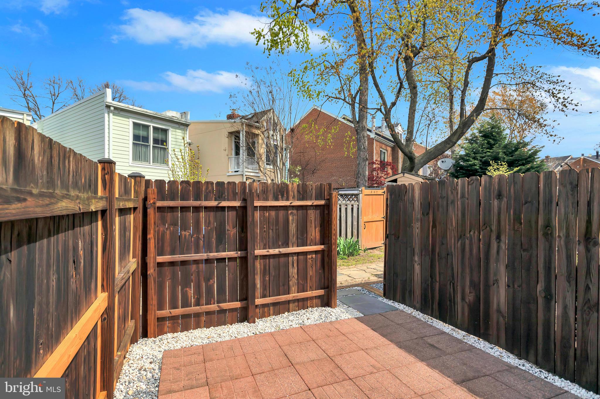 1437 Duke Street Alexandria, VA 22314 - Photo 29 of 45 a view of backyard with wooden fence and trees