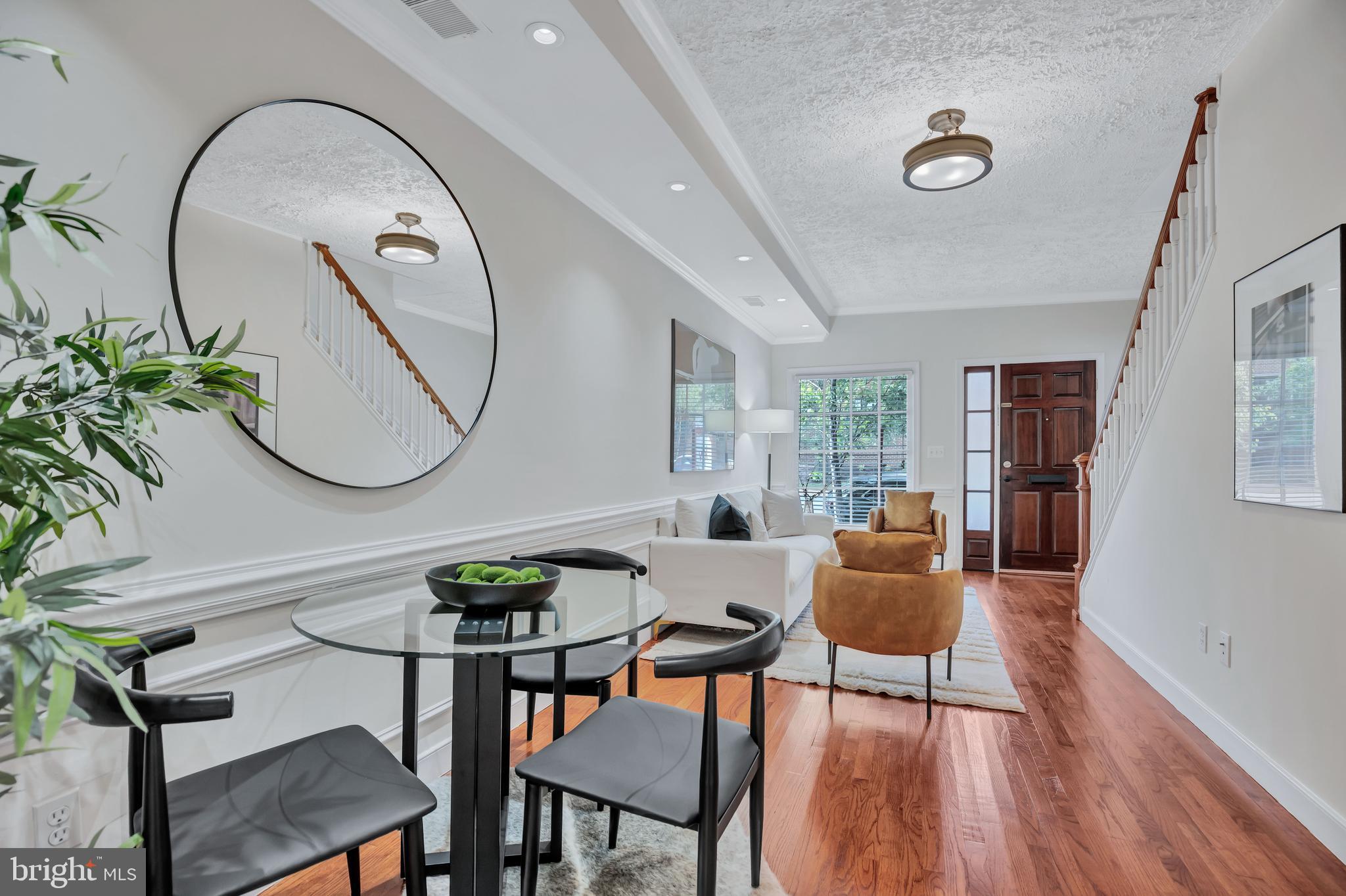 1437 Duke Street Alexandria, VA 22314 - Photo 7 of 45 a living room with furniture a mirror and a potted plant
