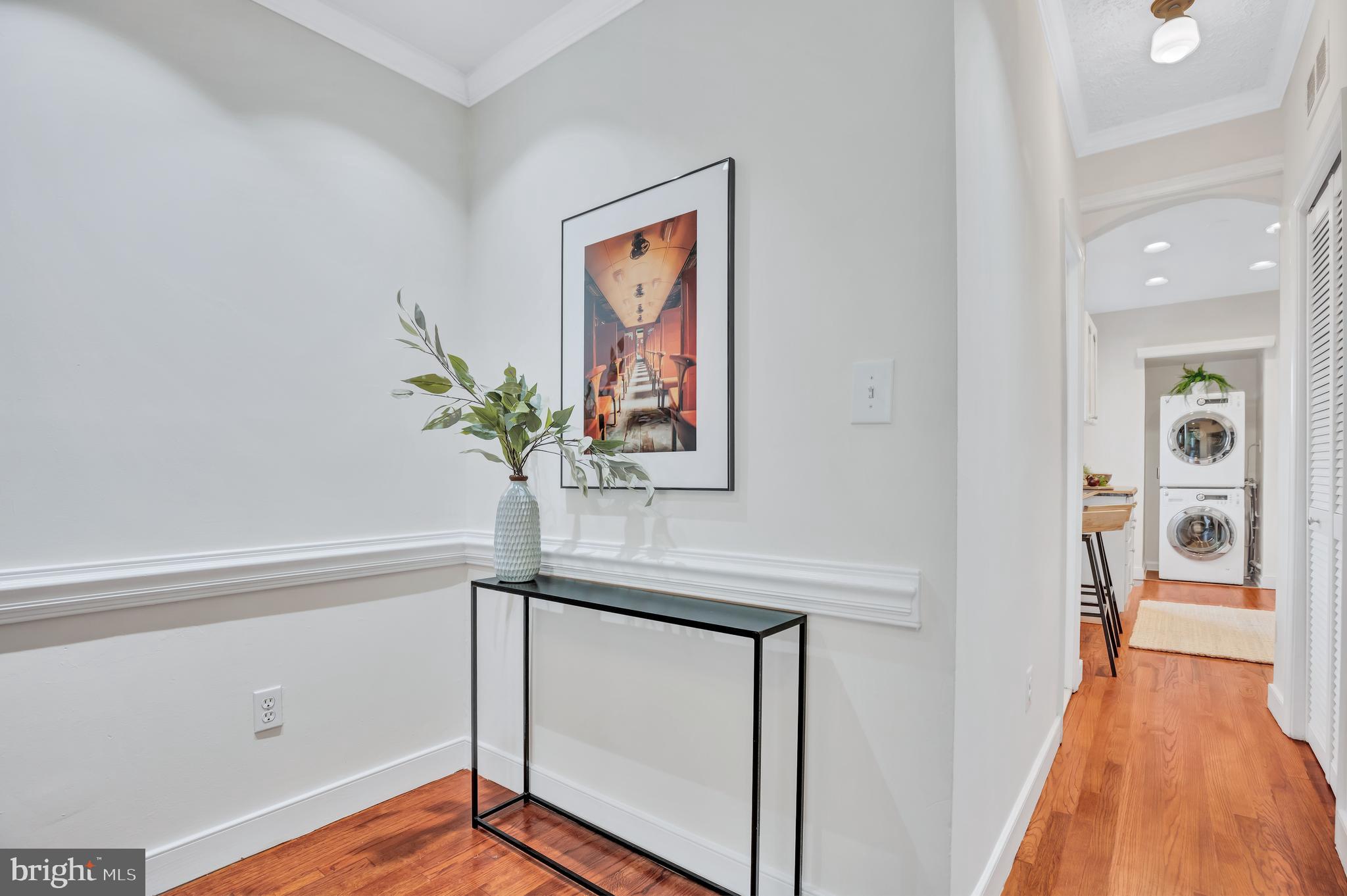 1437 Duke Street Alexandria, VA 22314 - Photo 9 of 45 a view of a hallway with wooden floor and glass top table