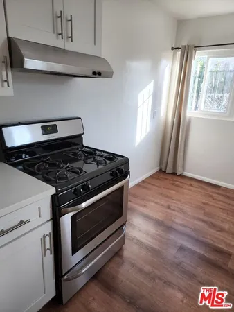 a stove top oven sitting inside of a kitchen
