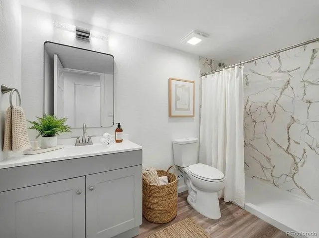 a bathroom with a sink toilet and shower