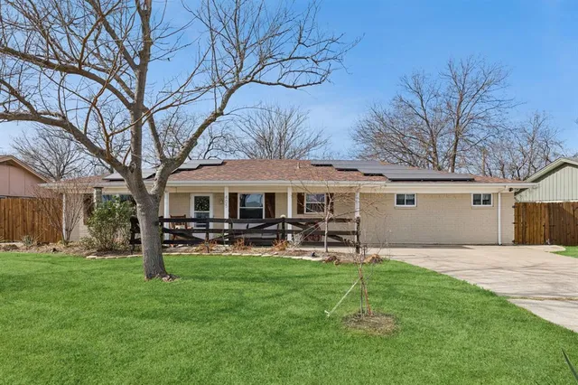 a view of a house with backyard porch and sitting area