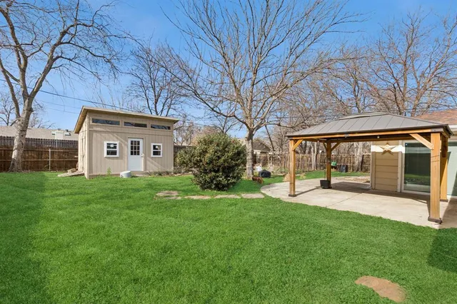 a view of a house with a yard and sitting area
