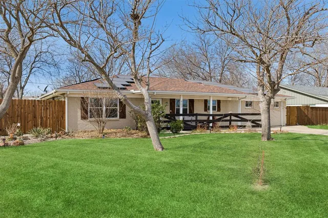 a view of a house with a yard and sitting area
