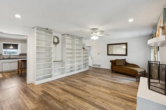 a view of a bedroom with furniture and wooden floor