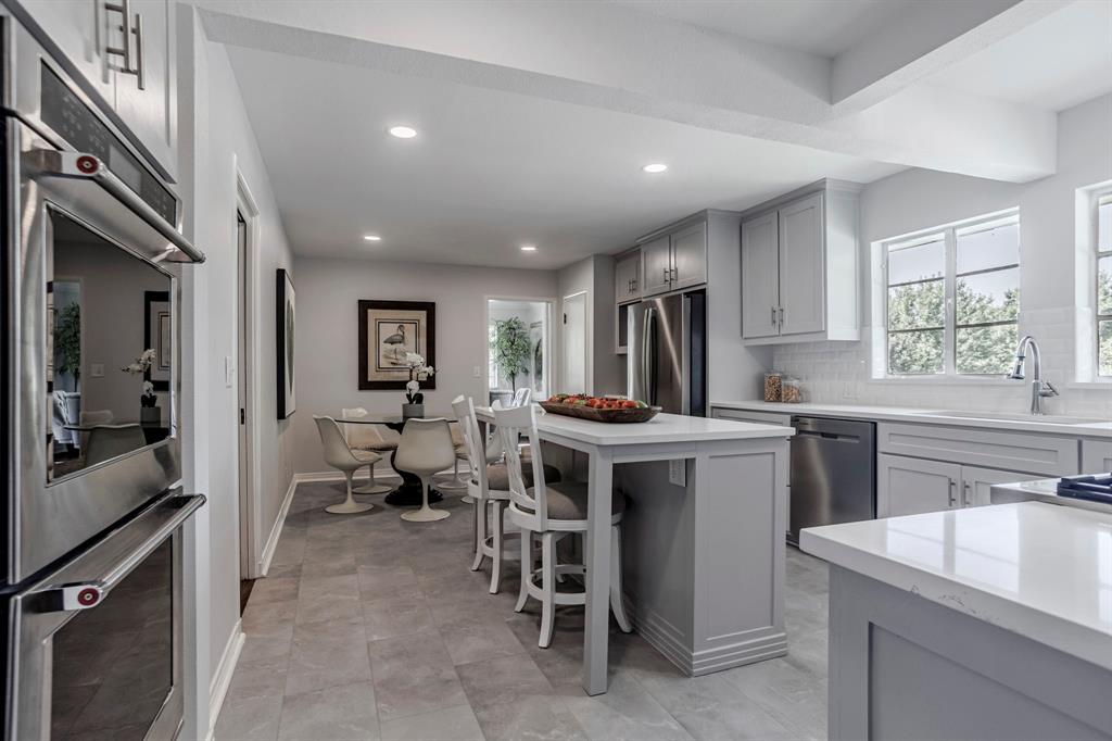 a kitchen with counter top space appliances and windows