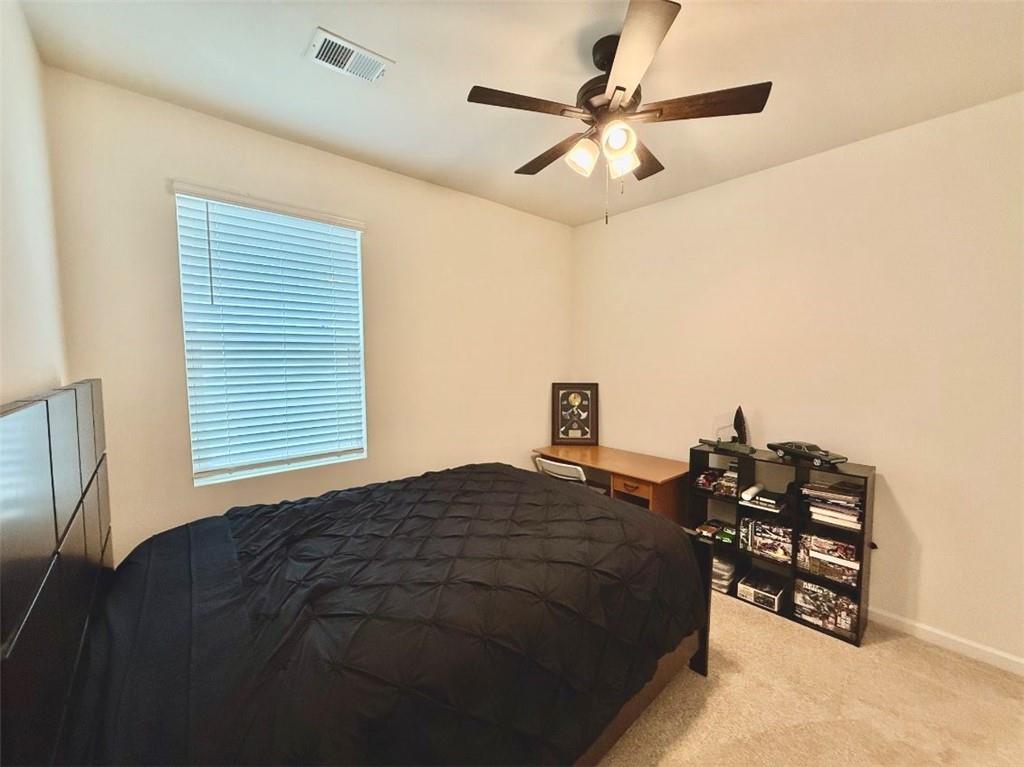 2015 Waycross Lane Dacula, GA 30019 - Photo 13 of 49 a bedroom with a bed and a chandelier
