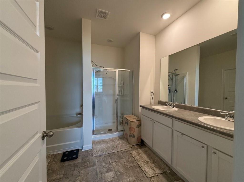2015 Waycross Lane Dacula, GA 30019 - Photo 31 of 49 a bathroom with a double vanity sink toilet and shower
