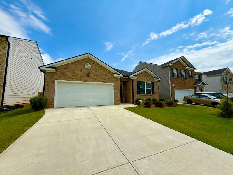 2015 Waycross Lane Dacula, GA 30019 - Photo 5 of 49 a front view of a house with a yard and garage