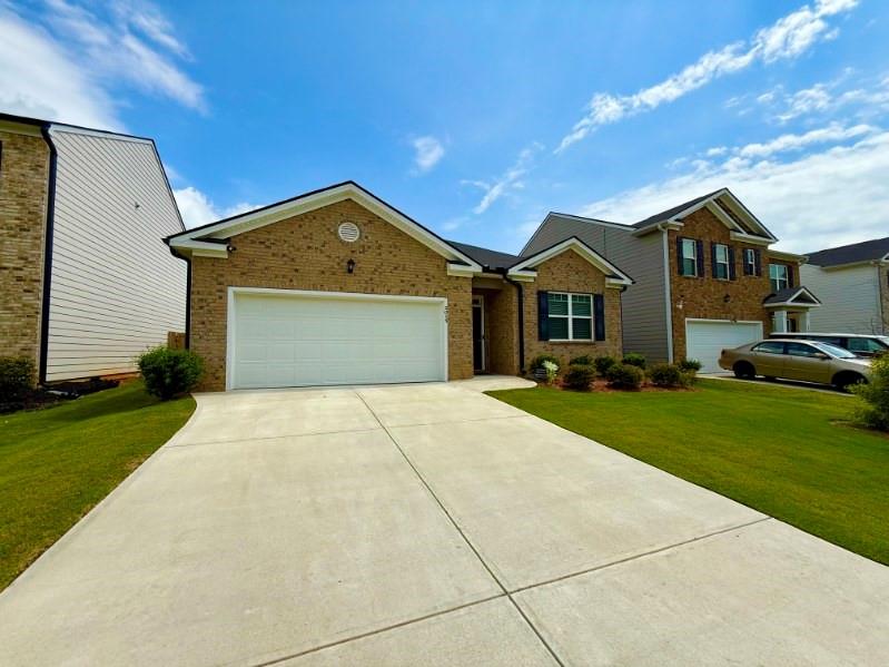 2015 Waycross Lane Dacula, GA 30019 - Photo 6 of 49 a front view of a house with a yard and garage