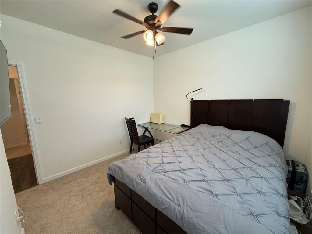 2015 Waycross Lane Dacula, GA 30019 - Photo 8 of 49 a bedroom with a bed and a ceiling fan