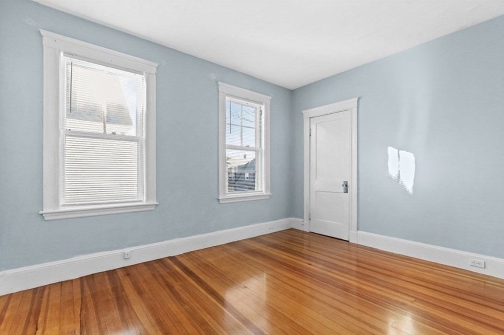 141 4th Street Medford, MA 02155 - Photo 15 of 26 a view of empty room with wooden floor and fan