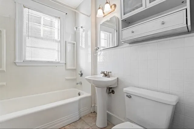 a bathroom with a sink a toilet and bathtub