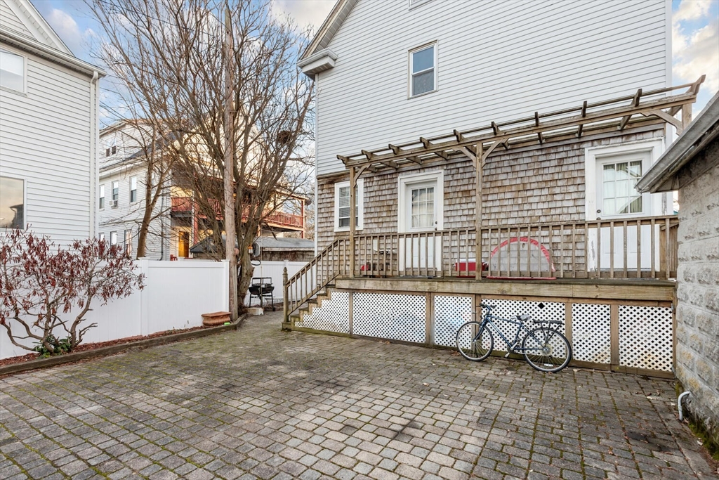 141 4th Street Medford, MA 02155 - Photo 25 of 26 a house view with a backyard and wooden fence