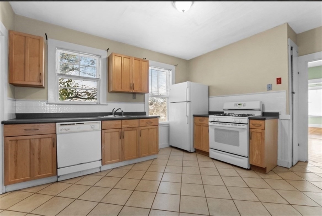 141 4th Street Medford, MA 02155 - Photo 9 of 26 a kitchen with a stove sink and cabinets