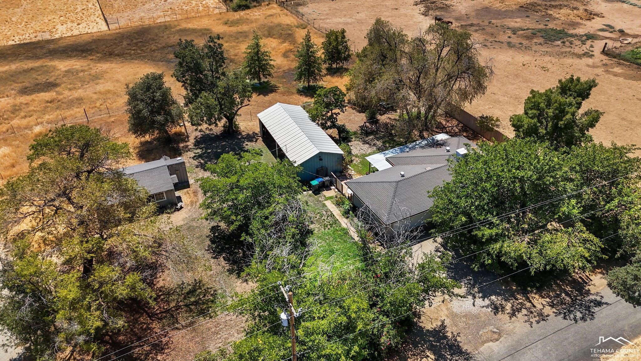 22275 Brent Road Red Bluff, CA 96080 - Photo 3 of 47 an aerial view of a house with a yard and trees