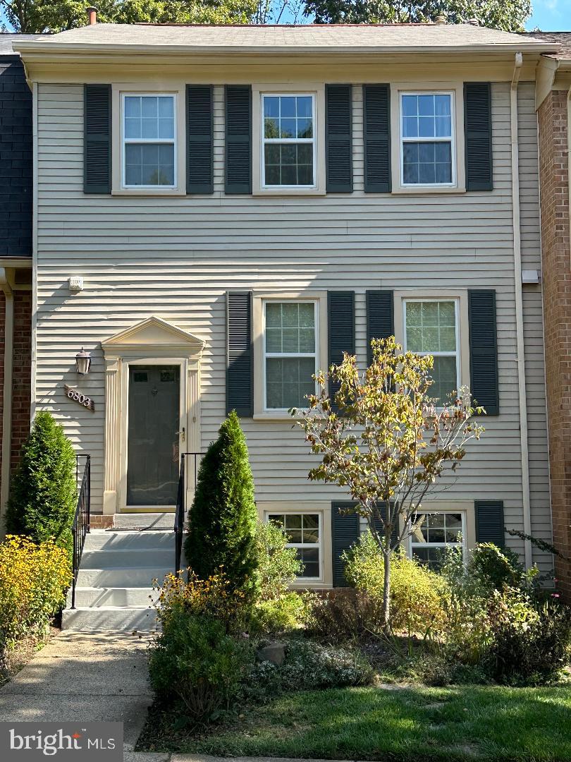 6803 Wild Rose Court Springfield, VA 22152 - Photo 1 of 49 a front view of a house with garden