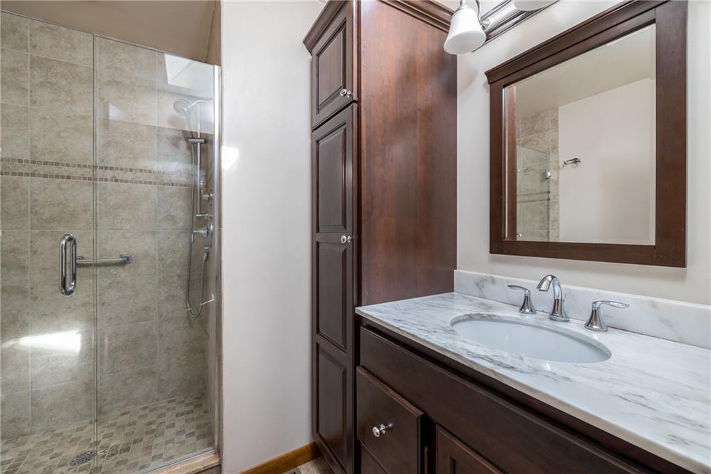 17 Cranberry Lane Cecil, PA 15321 - Photo 14 of 25 a bathroom with a granite countertop sink a mirror and shower